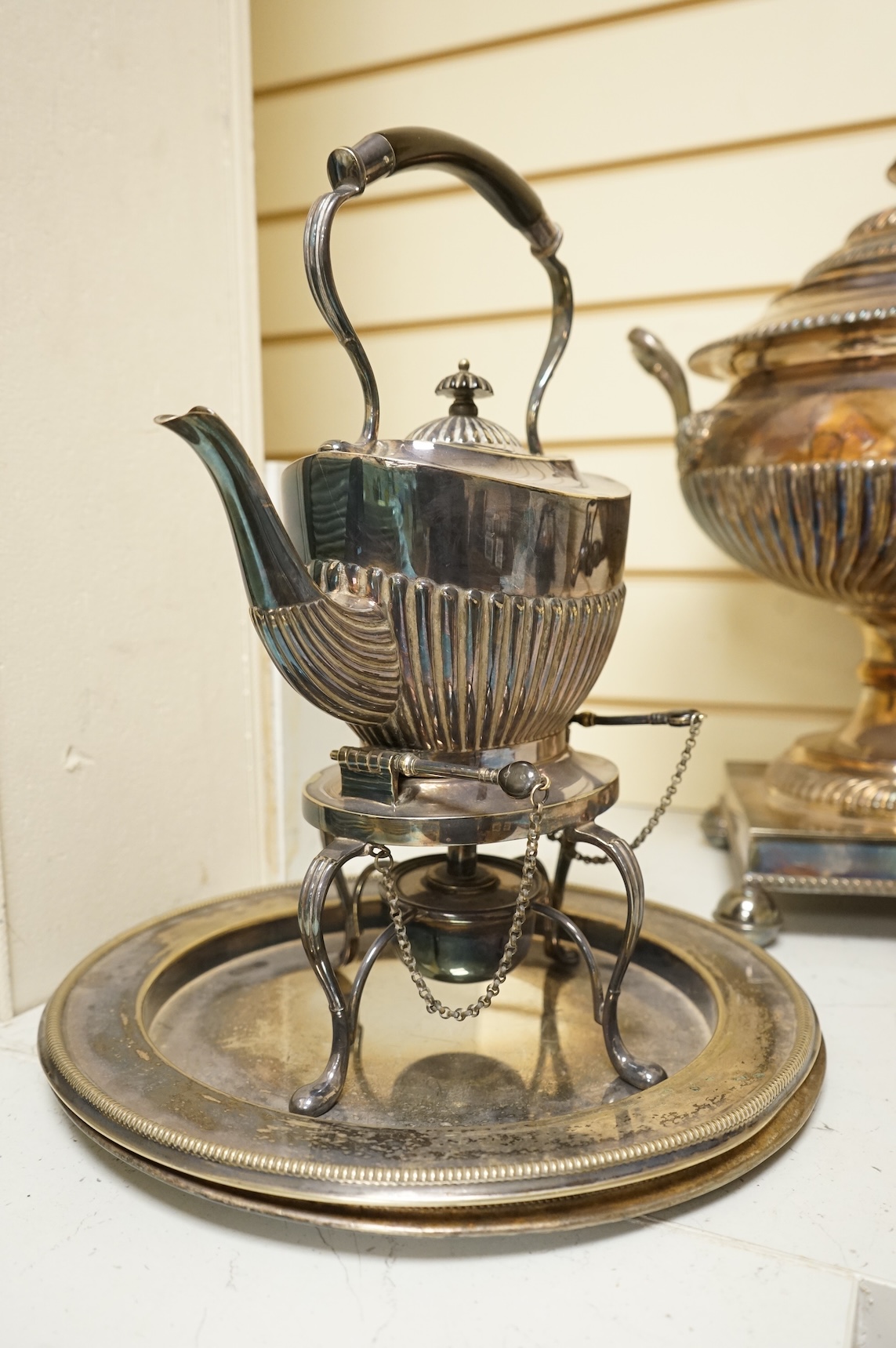 A Victorian silver plated urn, height 42cm, a silver plated spirit kettle and two circular dishes.